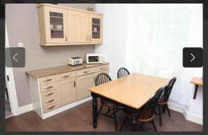 a kitchen with a table and chairs and a microwave at City Centre Double Room in Truro +9 photos