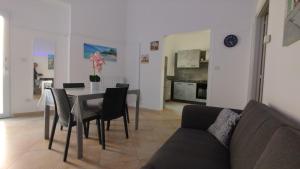 a living room with a table and a couch at D&M House Salento in Nardò
