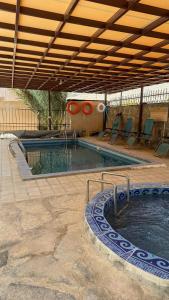 a large swimming pool with a swimming pool at The Wadi Inn in Al Ḩamrāʼ