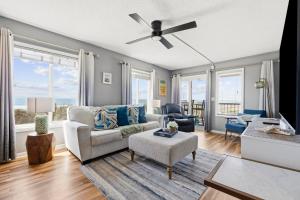 a living room with a couch and a ceiling fan at The Beach Is Back in Myrtle Beach