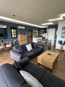 a living room with a couch and a table at 26 Villa Katerina, Elani in Elani