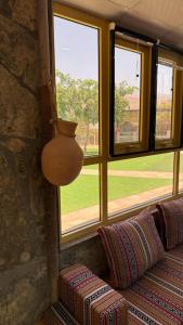 a room with windows and a vase on the wall at The Wadi Inn in Al Ḩamrāʼ +55 photos