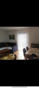 a living room with a couch and a table at Mostar kuca pored jezera in Mostar