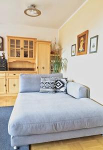 a living room with a blue couch in a room at Ferienhaus Ströbl in Liesing +16 photos