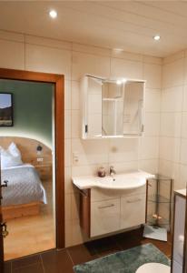 a bathroom with a sink and a bed at Ferienhaus Ströbl in Liesing
