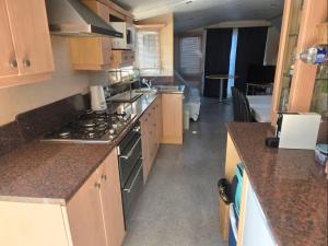 a kitchen with a stove top oven in a room at La cabane des fées in Yvoir +10 photos