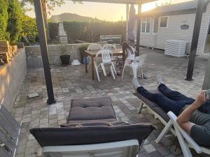 two people laying on chairs on a patio at La cabane des fées in Yvoir