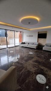 a large living room with couches and a television at Çözel Sare Hotel in Güzelçamlı
