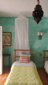 a bedroom with a bed with a white curtain at Monte dos Duques in Santo Estêvão +80 photos