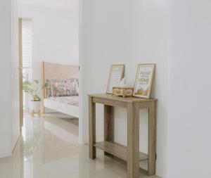 a table in a living room with a couch at Riverview Loft in Iloilo City +3 photos