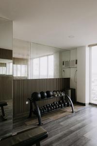 a room with a bench with bowls on it at Riverview Loft in Iloilo City