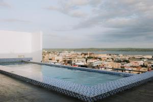 a swimming pool on the roof of a building at Riverview Loft in Iloilo City