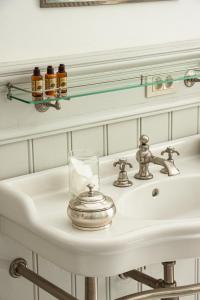 a bathroom sink with a glass on it at Castle B&B Castanea in Merelbeke +52 photos