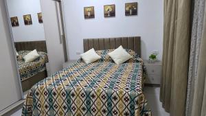 a bedroom with a bed and a mirror at Solara in Hurghada