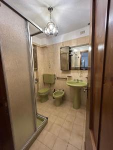 a bathroom with two toilets and a sink and a mirror at La meison de Rita in Pré-Saint-Didier +9 photos