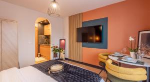 a hotel room with a bed and a desk and a room at Studio moderne chaleureux et calme in Annecy