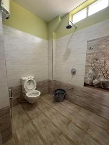 a bathroom with a toilet and a shower at The Luxora Villa in Kuilapayam +16 photos