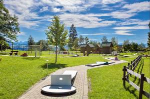 a laptop computer sitting on a bench in a park at Allgäuauszeit mit Bergblick - Sauna - Balkon in Scheidegg