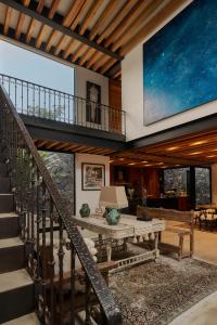 a living room with a table and a large screen at Casa Carmen Xólotl in Oaxaca City