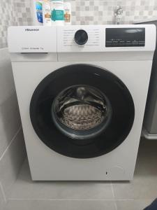 a white washing machine with its door open at Domus NAUSICA in Cologno al Serio