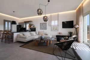 a living room with a couch and a table at Didimos Luxury Villas in Cherronisos +95 photos