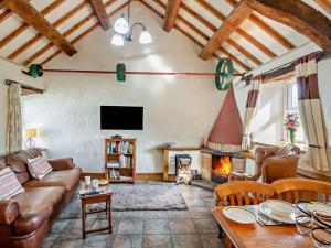 a living room with a couch and a fireplace at 2 Bed in Conwy oc-95905 in Conwy