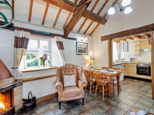 a kitchen and dining room with a table and a fireplace at 2 Bed in Conwy oc-95905 in Conwy
