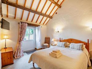 a bedroom with a bed with two towels on it at 2 Bed in Conwy oc-95905 in Conwy