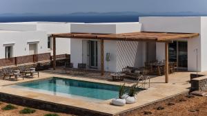 a villa with a swimming pool and a house at Didimos Luxury Villas in Cherronisos