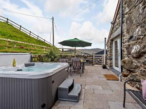 a hot tub on the patio of a house at 3 Bed in Bala oc-52810 in Llanuwchllyn