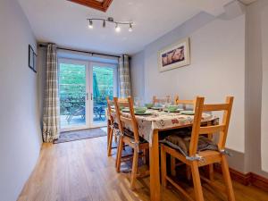 a dining room with a table and wooden chairs at 3 Bed in Bala oc-52810 in Llanuwchllyn +14 photos