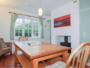 a dining room with a wooden table and chairs at The lodge in Bodmin