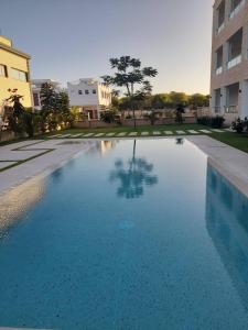 a large blue swimming pool in a building at Sandbox Apartment 4 Diani Beach Kenya in Ukunda