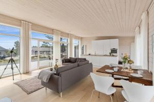 a living room with a couch and a table at Seaside Escape - 10 Min to Ocean in Ytre Søndeled