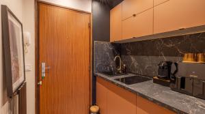 a kitchen with a sink and a counter top at Studio moderne chaleureux et calme in Annecy