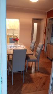 a dining room with a table and chairs and a kitchen at La pergola in Sagliano Micca