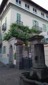 a building with a fountain in front of it at La pergola in Sagliano Micca