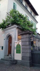 a building with a green sign in front of it at La pergola in Sagliano Micca +7 photos