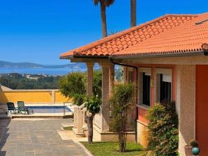 a house with a patio and a swimming pool at La Pepa Sanxenxo in Sanxenxo