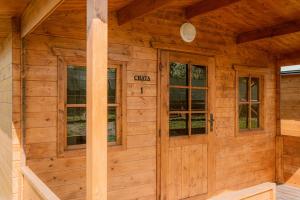a cabin with wooden walls and windows at U Bernarda in Slavíkovice