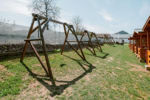 a row of wooden swings in a park at U Bernarda in Slavíkovice