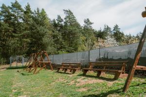 two benches and a swing set in a park at U Bernarda in Slavíkovice +41 photos