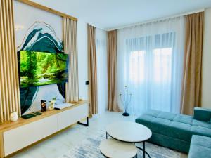 a living room with a couch and a table at Apartman Romanija Wellness & Spa in Potoci