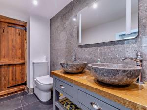 a bathroom with two sinks and a toilet at 1 Bed in Matlock oc-75400 in Middleton +16 photos