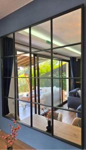 a mirror on a wall in a living room at 26 Villa Katerina, Elani in Elani