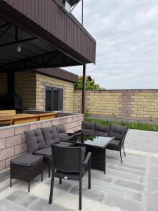 a patio with couches and a table and chairs at Mughni home in Ashtarak