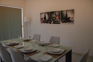 a dining room with a table with chairs at Modern 3 bedroom with AC apartment in Żabbar