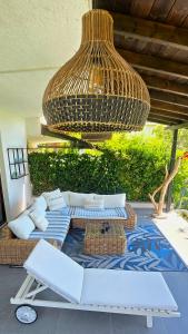 a patio with white couches and a large chandelier at 26 Villa Katerina, Elani in Elani