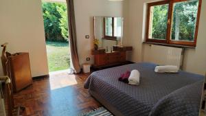a bedroom with a bed and a large mirror at La Caldara House in Manziana