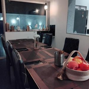 a dining room table with a basket of fruit on it at Casa Oceanus - Pool View Room - Ganpatipule in Nevra